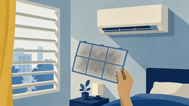 A hand holding an aircon filter up to the window light, grey with dust